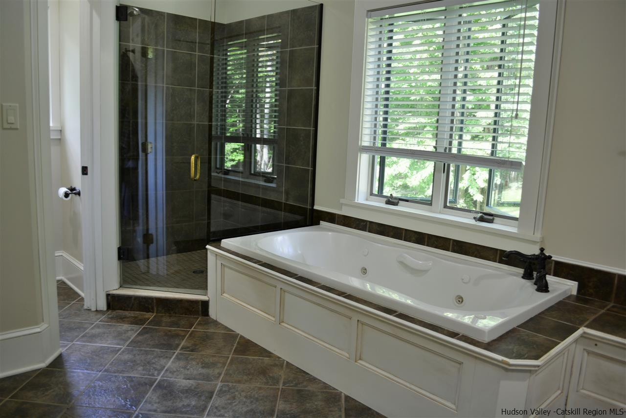 4651 Atwood Road Stone Ridge, NY 12484 - Photo 23 of 31 a bath tub sitting in a bathroom next to a window