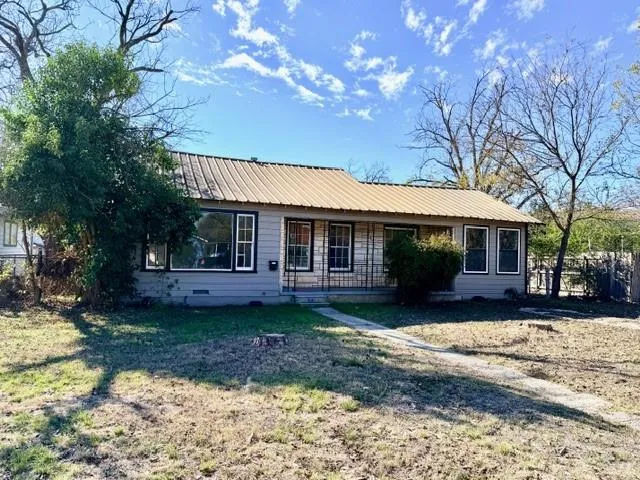 a front view of a house with a garden and porch