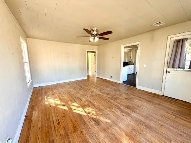 wooden floor in an empty room with a window