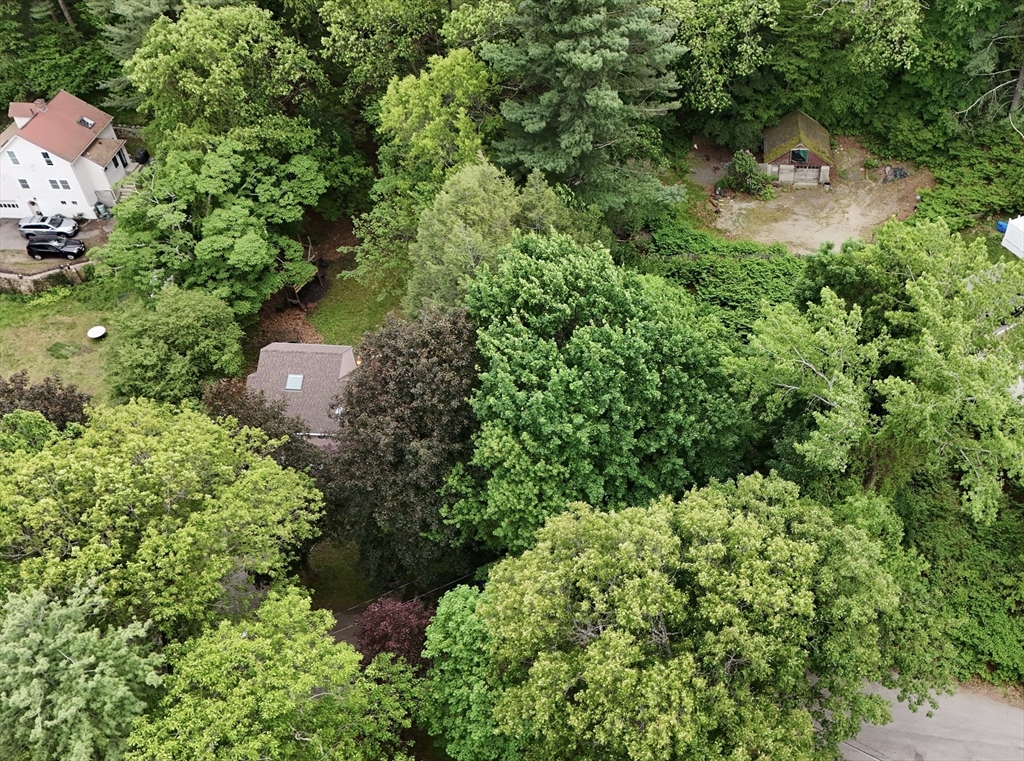 an aerial view of a house with a yard and outdoor space