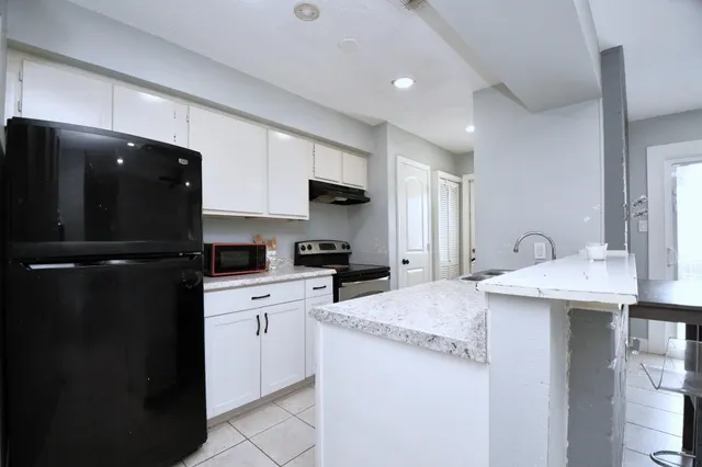 a kitchen with a sink a stove and refrigerator