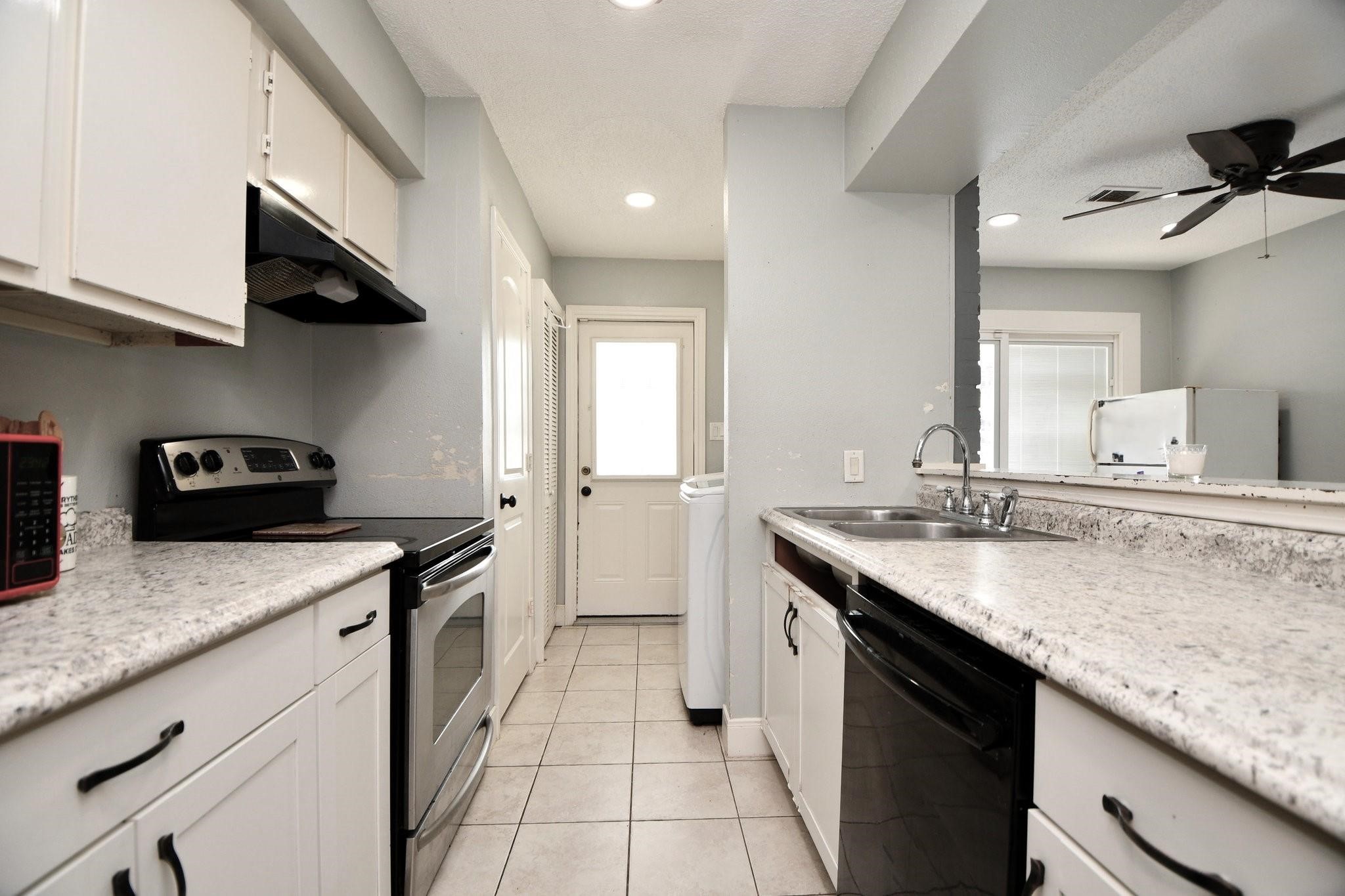 9458 Neuens Road, Unit 9458 Houston, TX 77080 - Photo 15 of 18 a kitchen with stainless steel appliances granite countertop a sink stove and cabinets