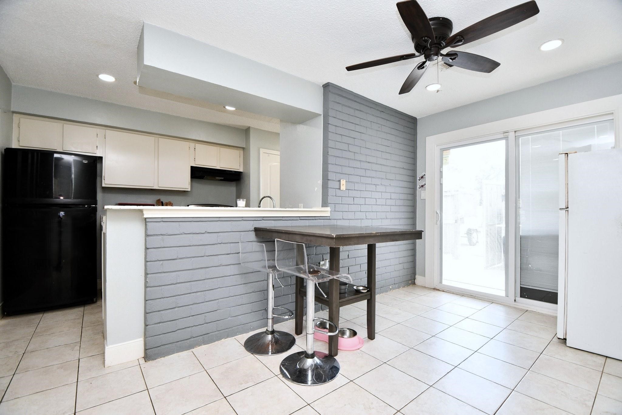 9458 Neuens Road, Unit 9458 Houston, TX 77080 - Photo 16 of 18 a kitchen with stainless steel appliances kitchen island granite countertop a refrigerator and a stove