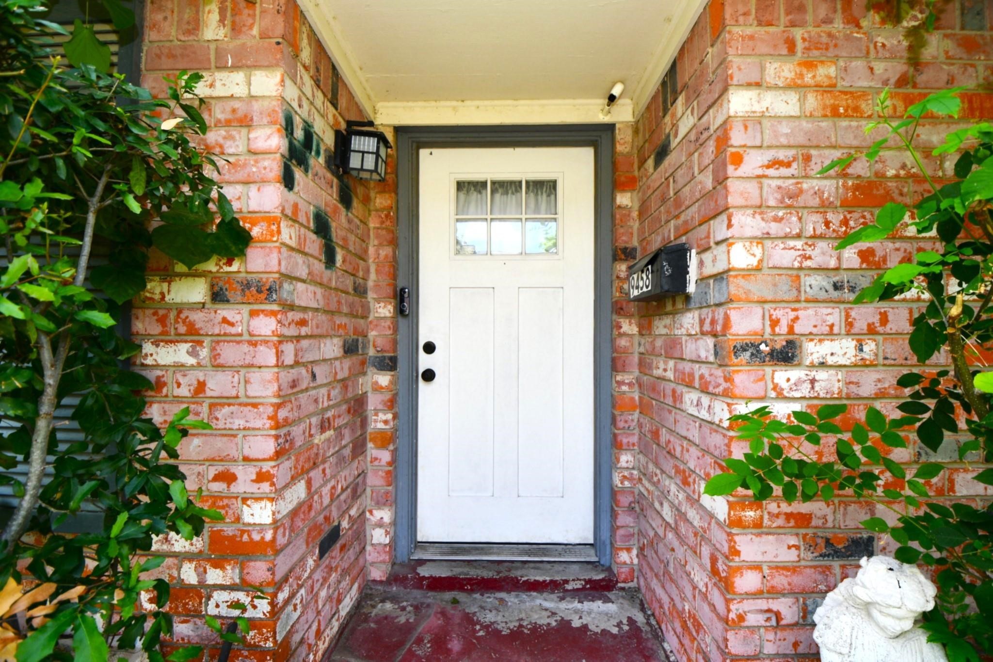9458 Neuens Road, Unit 9458 Houston, TX 77080 - Photo 2 of 18 a front view of a house with a garden
