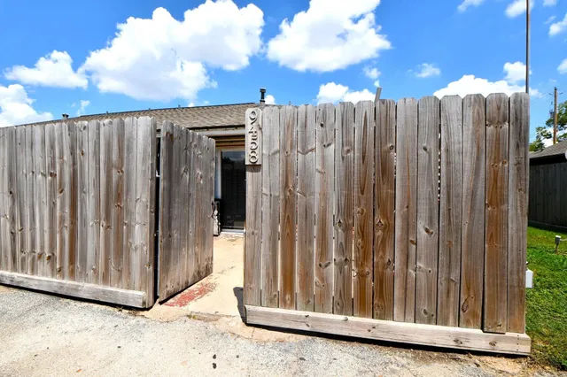 a view of a wooden fence next to a house