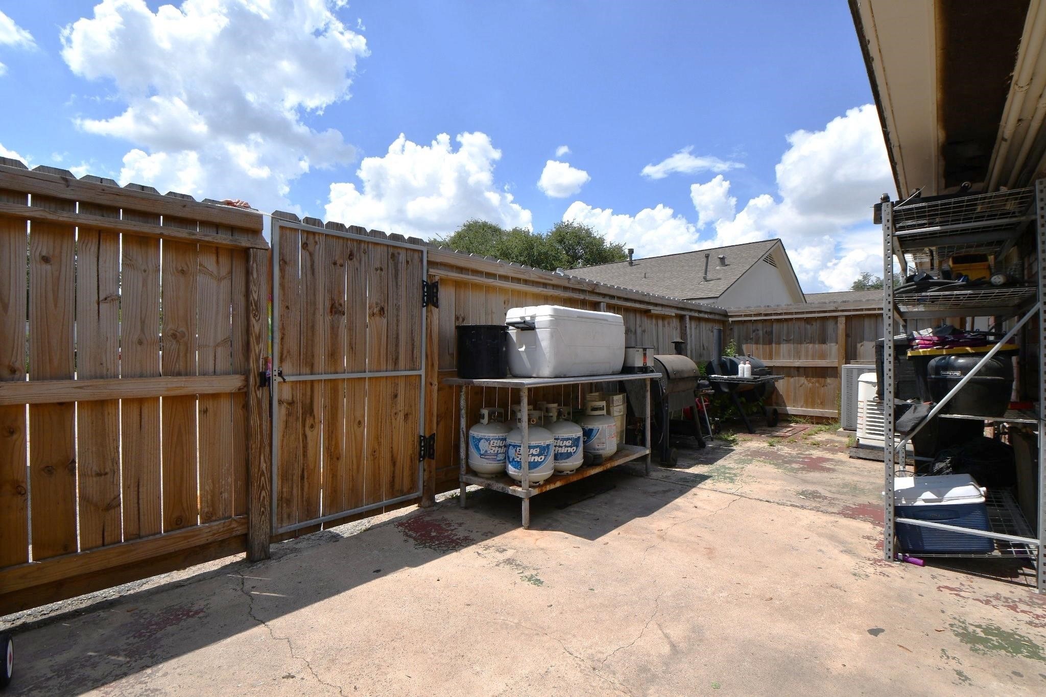 9458 Neuens Road, Unit 9458 Houston, TX 77080 - Photo 4 of 18 a view of a house with a wooden fence