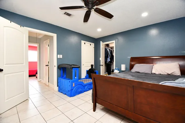 a bedroom with furniture and a chandelier
