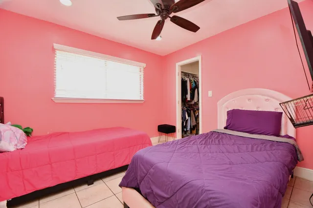 a bedroom with a bed and a mirror