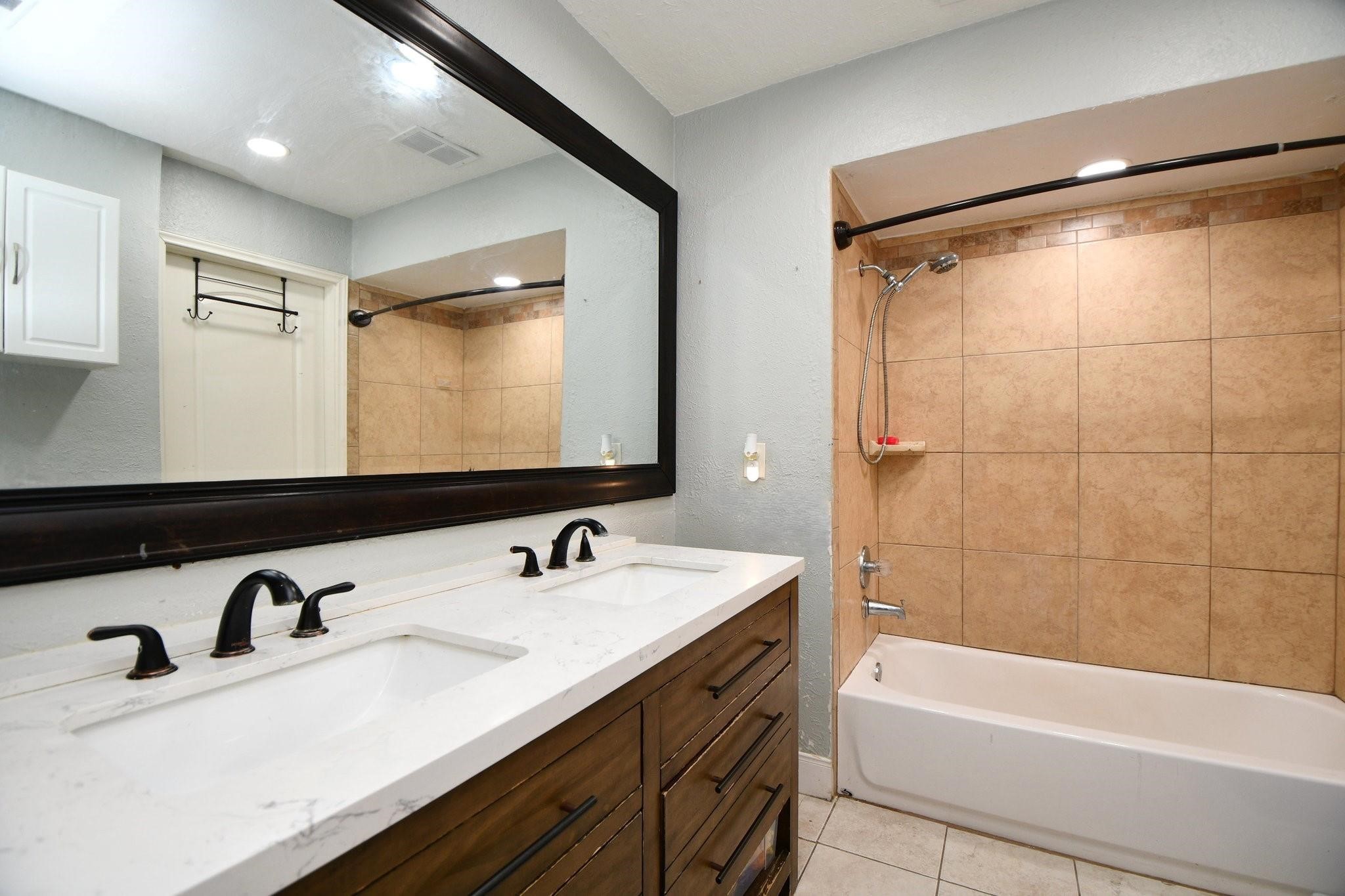 9458 Neuens Road, Unit 9458 Houston, TX 77080 - Photo 10 of 18 a bathroom with a sink and a bathtub