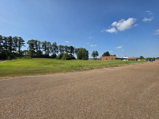 a view of a field and a building in the background
