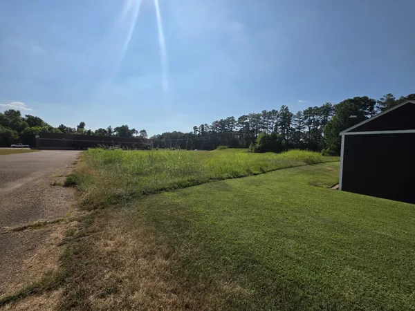 a view of a field with an trees