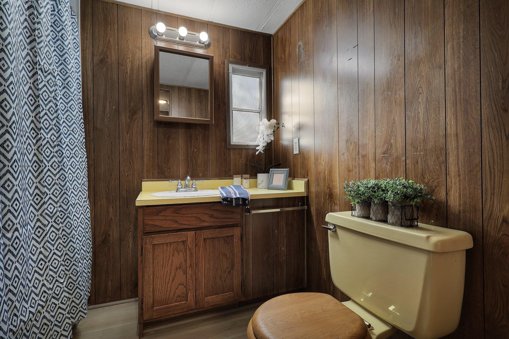7680 Happy Valley Road Anderson, CA 96007 - Photo 15 of 39 a bathroom with a toilet a sink and mirror