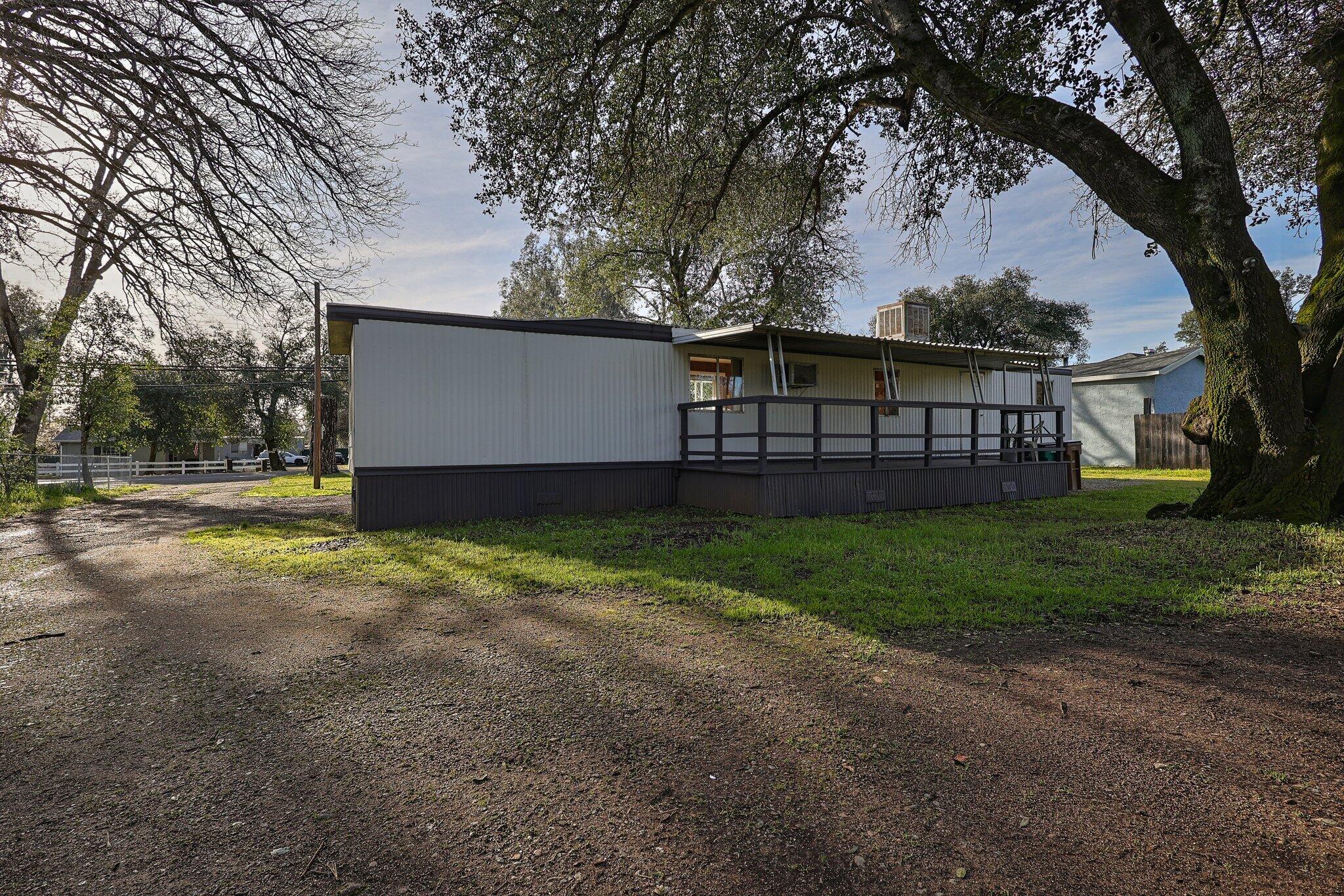 7680 Happy Valley Road Anderson, CA 96007 - Photo 22 of 39 a view of a house with a yard and a large tree
