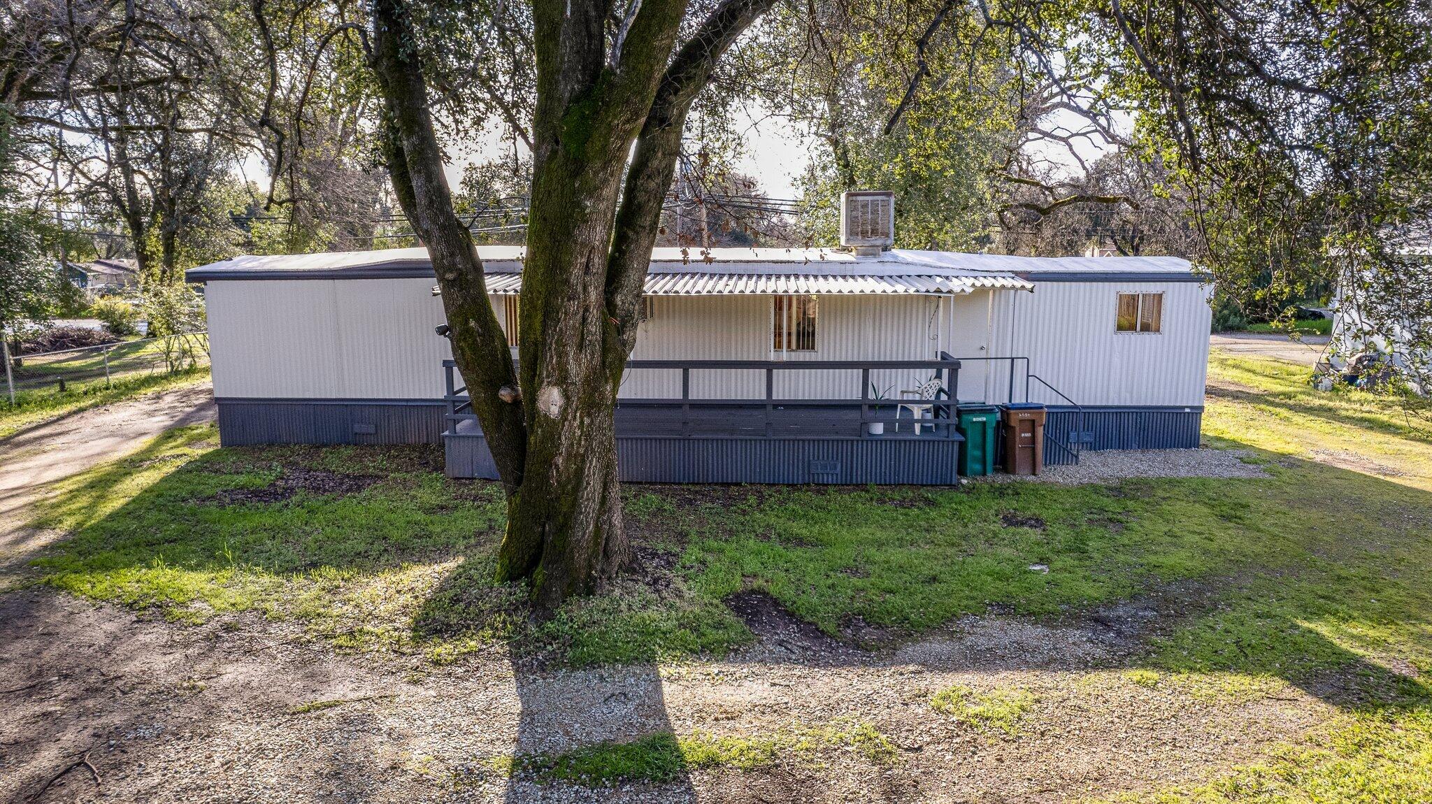 7680 Happy Valley Road Anderson, CA 96007 - Photo 32 of 39 a view of a house with backyard and a tree