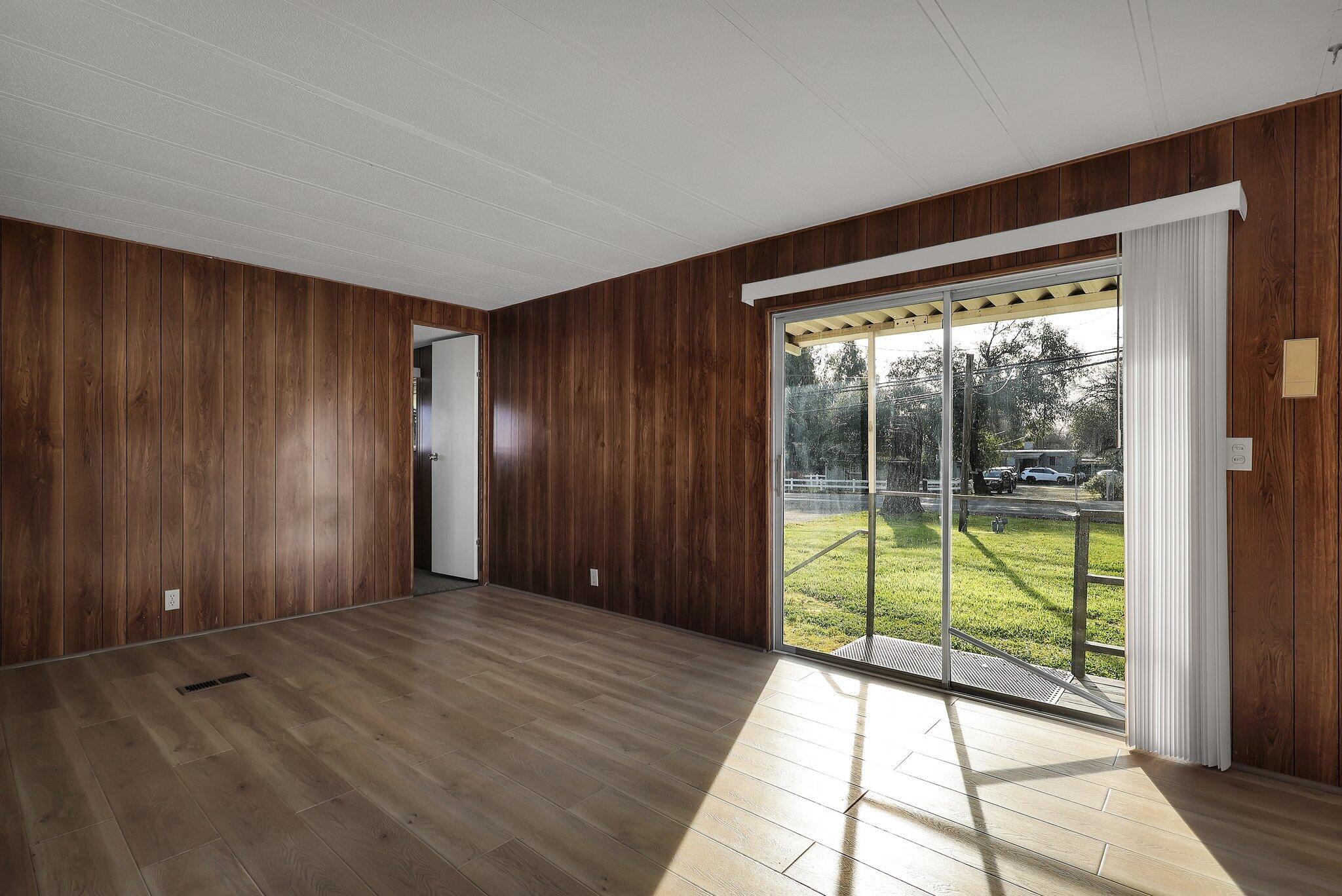 7680 Happy Valley Road Anderson, CA 96007 - Photo 6 of 39 wooden floor in an empty room with windows