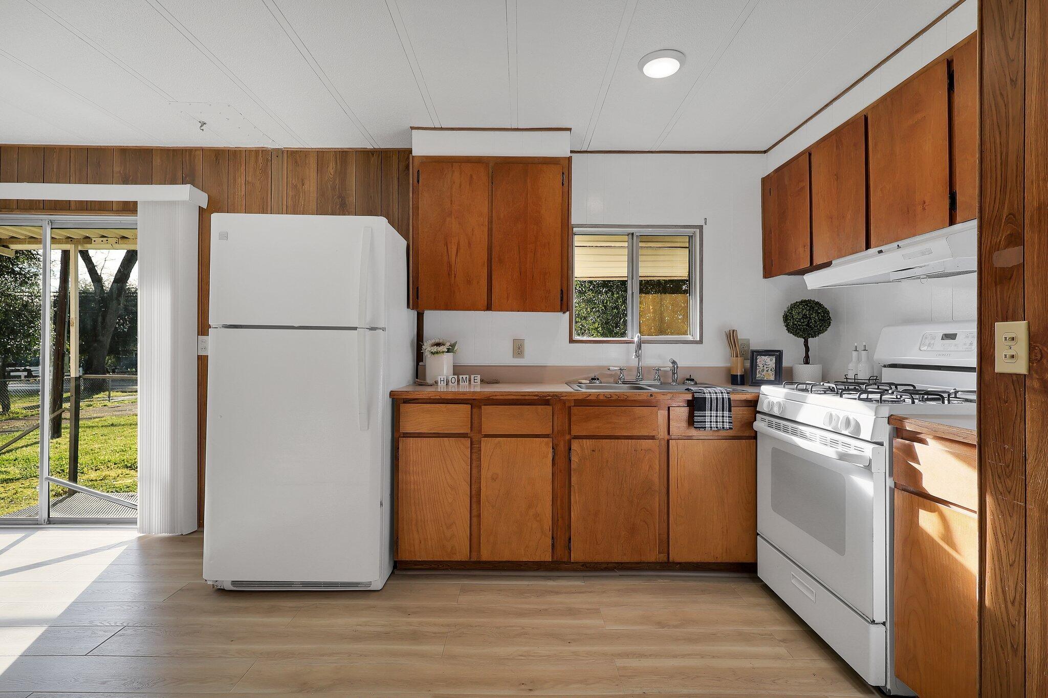 7680 Happy Valley Road Anderson, CA 96007 - Photo 9 of 39 a kitchen with sink a refrigerator and white appliances
