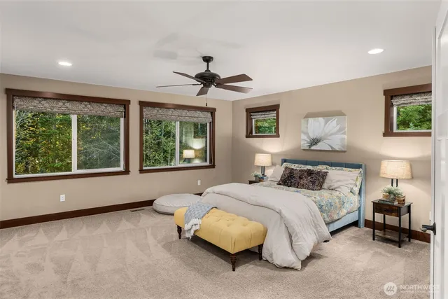 a bedroom with a large bed and a chandelier