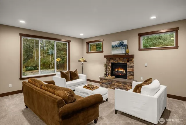 a living room with furniture large window and a fireplace