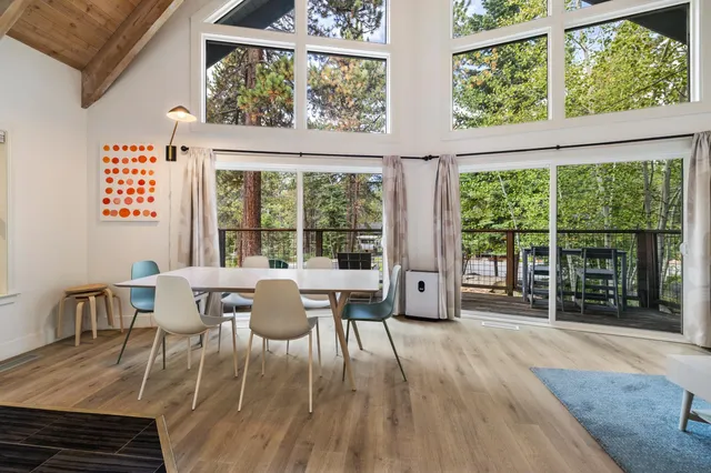 a dining room with furniture window and wooden floor