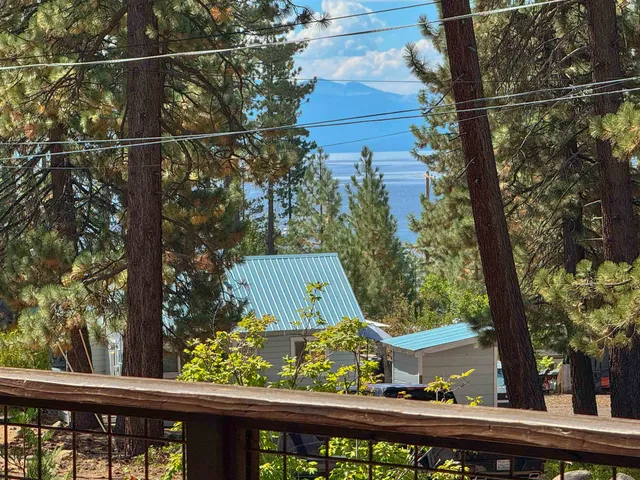 a view of a wooden fence and a tree