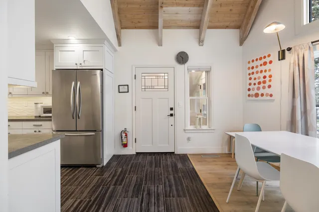 a kitchen with stainless steel appliances granite countertop a refrigerator and a stove top oven