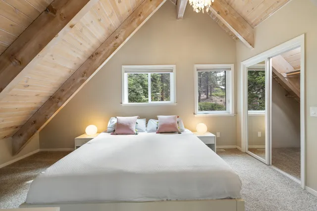 a bedroom with a large bed and a large window