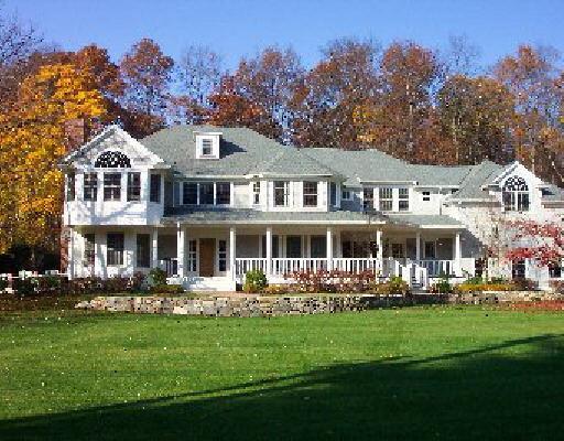a front view of a house with a yard table and chairs