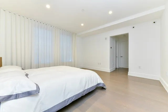 a bedroom with a bed and a painting