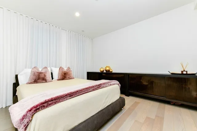 a bedroom with a bed and a cabinet