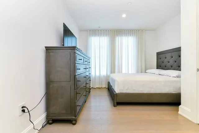 a bedroom with a bed and a dresser