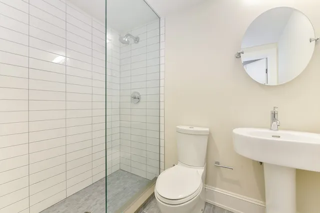 a white toilet sitting next to a bathroom sink