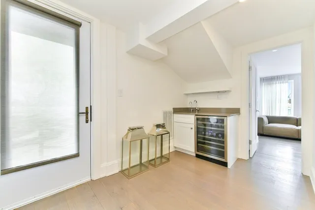 a view of a bedroom with furniture and window