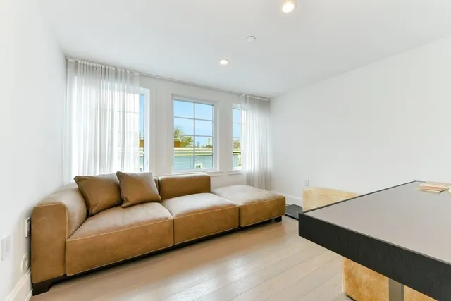 a bedroom with a bed couch and window