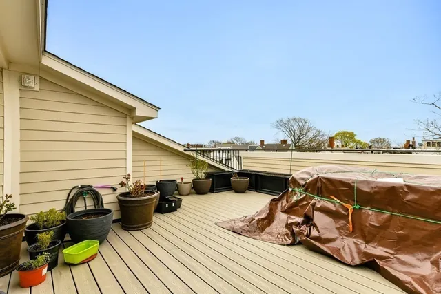 a view of a balcony with two chairs and wooden floor