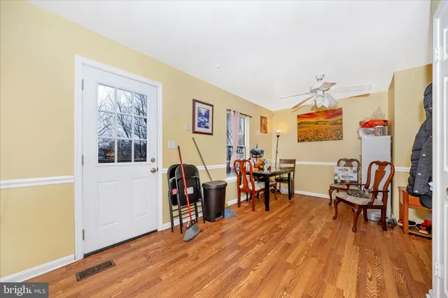 a view of a livingroom with furniture a flat screen tv and wooden floor