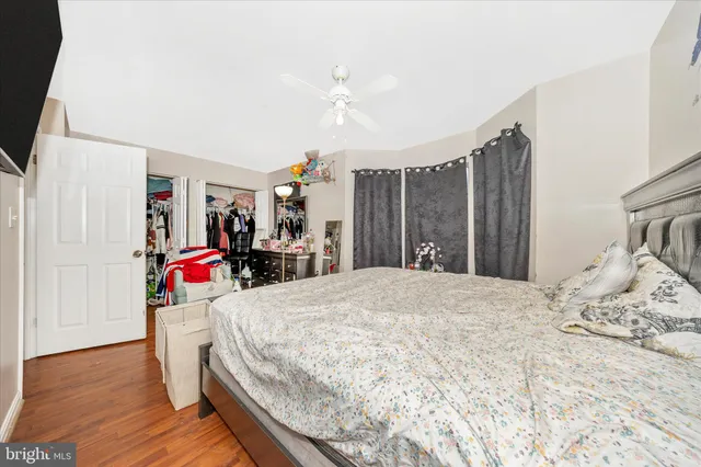 a room with a bed and wooden floor