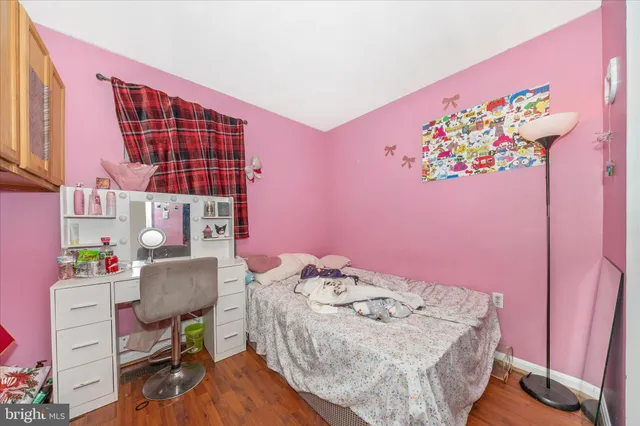 a bedroom with a bed and a desk