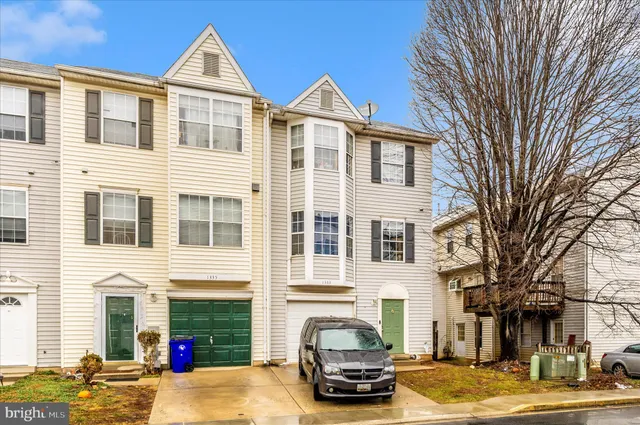 a front view of a residential apartment building with a yard