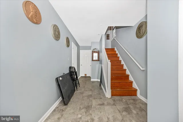 a view of entryway with furniture and stairs