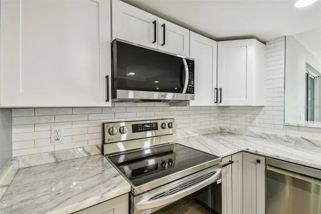 a view of a kitchen with furniture and windows