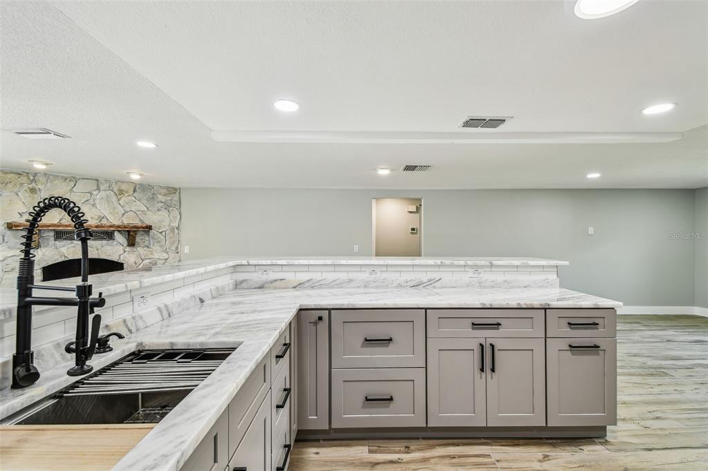 13909 Berkowitz Avenue Hudson, FL 34667 - Photo 14 of 91 a kitchen with stainless steel appliances granite countertop a stove and a sink