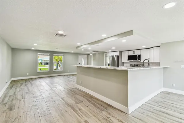 a living room with a fireplace and a rug