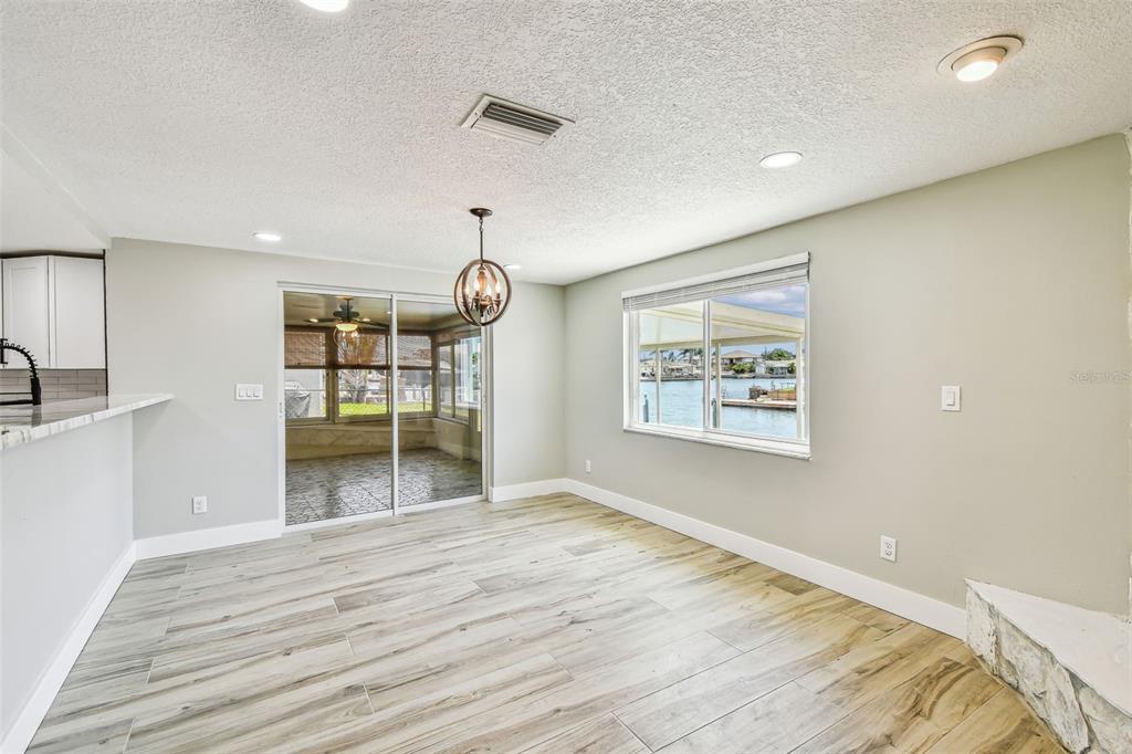 13909 Berkowitz Avenue Hudson, FL 34667 - Photo 17 of 91 a view of an empty room with wooden floor and a window