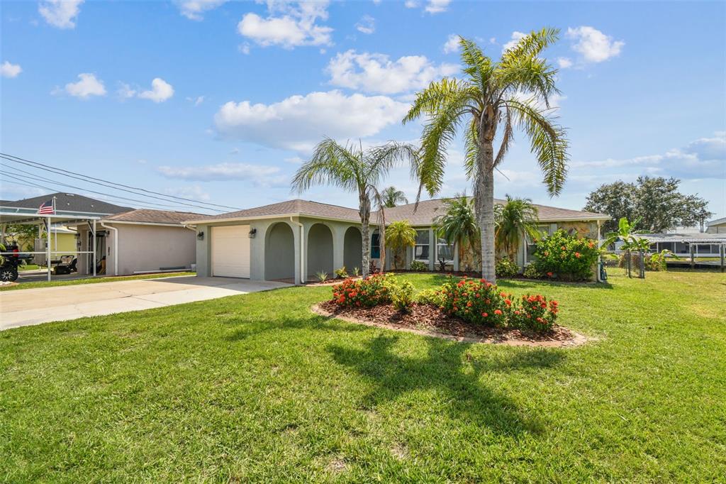 13909 Berkowitz Avenue Hudson, FL 34667 - Photo 2 of 91 a view of a house with swimming pool and a garden
