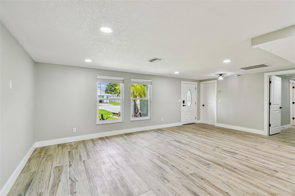 13909 Berkowitz Avenue Hudson, FL 34667 - Photo 22 of 91 a view of an empty room with wooden floor and window