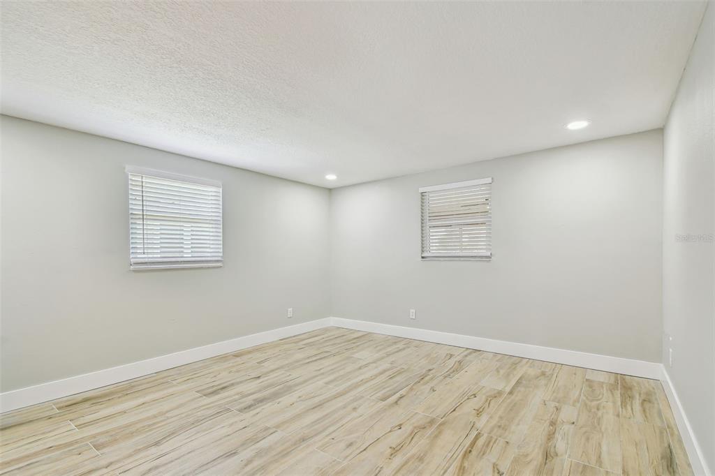 13909 Berkowitz Avenue Hudson, FL 34667 - Photo 26 of 91 a view of empty room with wooden floor and fan