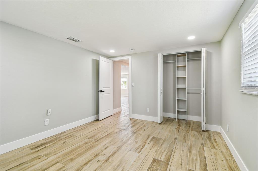 13909 Berkowitz Avenue Hudson, FL 34667 - Photo 39 of 91 wooden floor in an empty room with a window