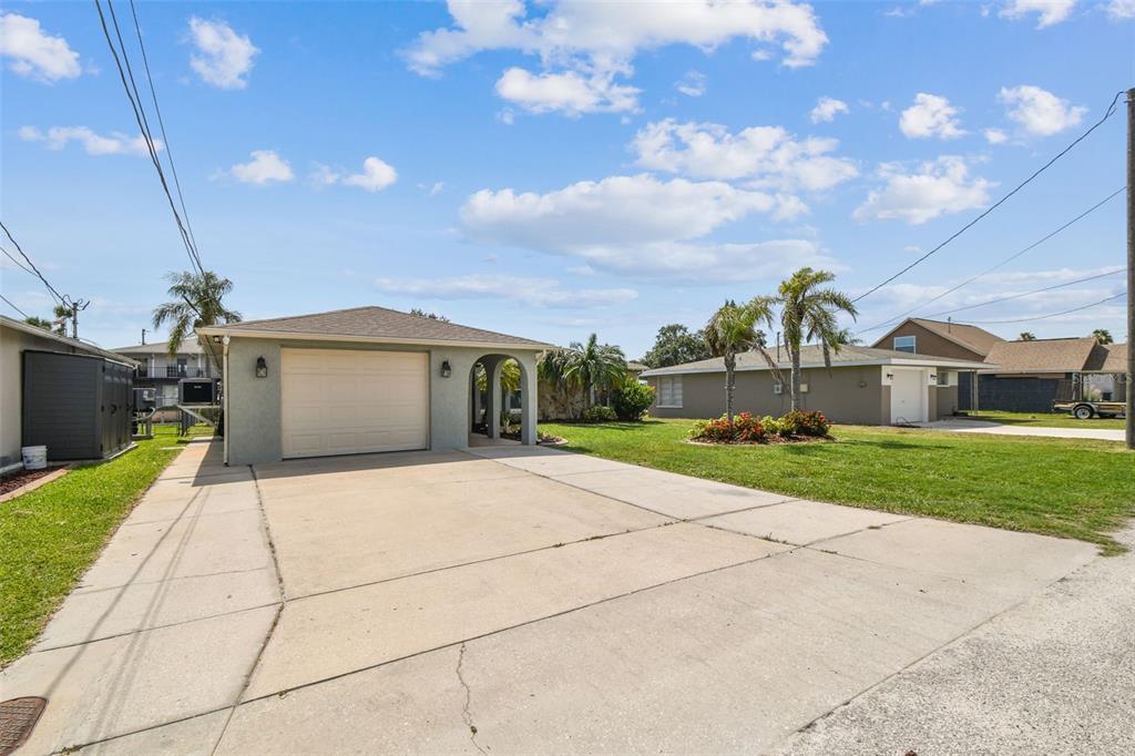 13909 Berkowitz Avenue Hudson, FL 34667 - Photo 4 of 91 a front view of a house with a yard and garage