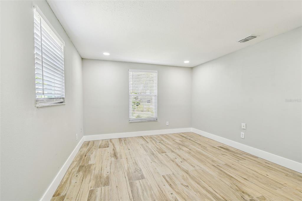 13909 Berkowitz Avenue Hudson, FL 34667 - Photo 41 of 91 an empty room with wooden floor and windows