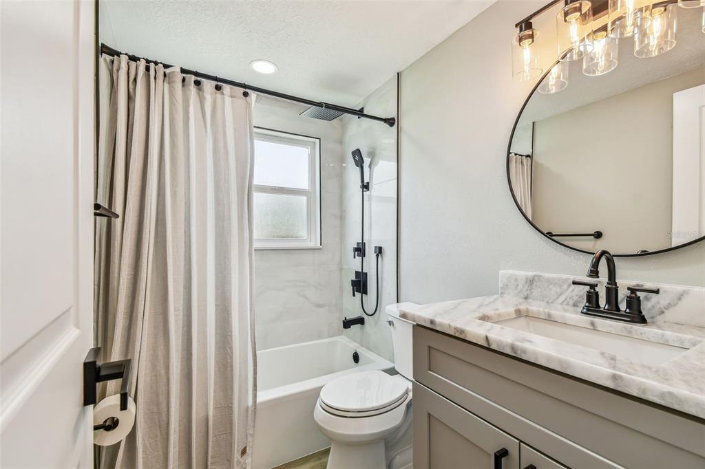 13909 Berkowitz Avenue Hudson, FL 34667 - Photo 42 of 91 a bathroom with a granite countertop sink toilet and shower